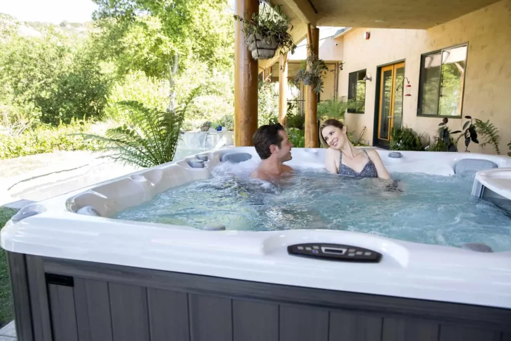 a young couple relaxing in the hot tub after work